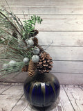 xmas decorating vase with pine cones