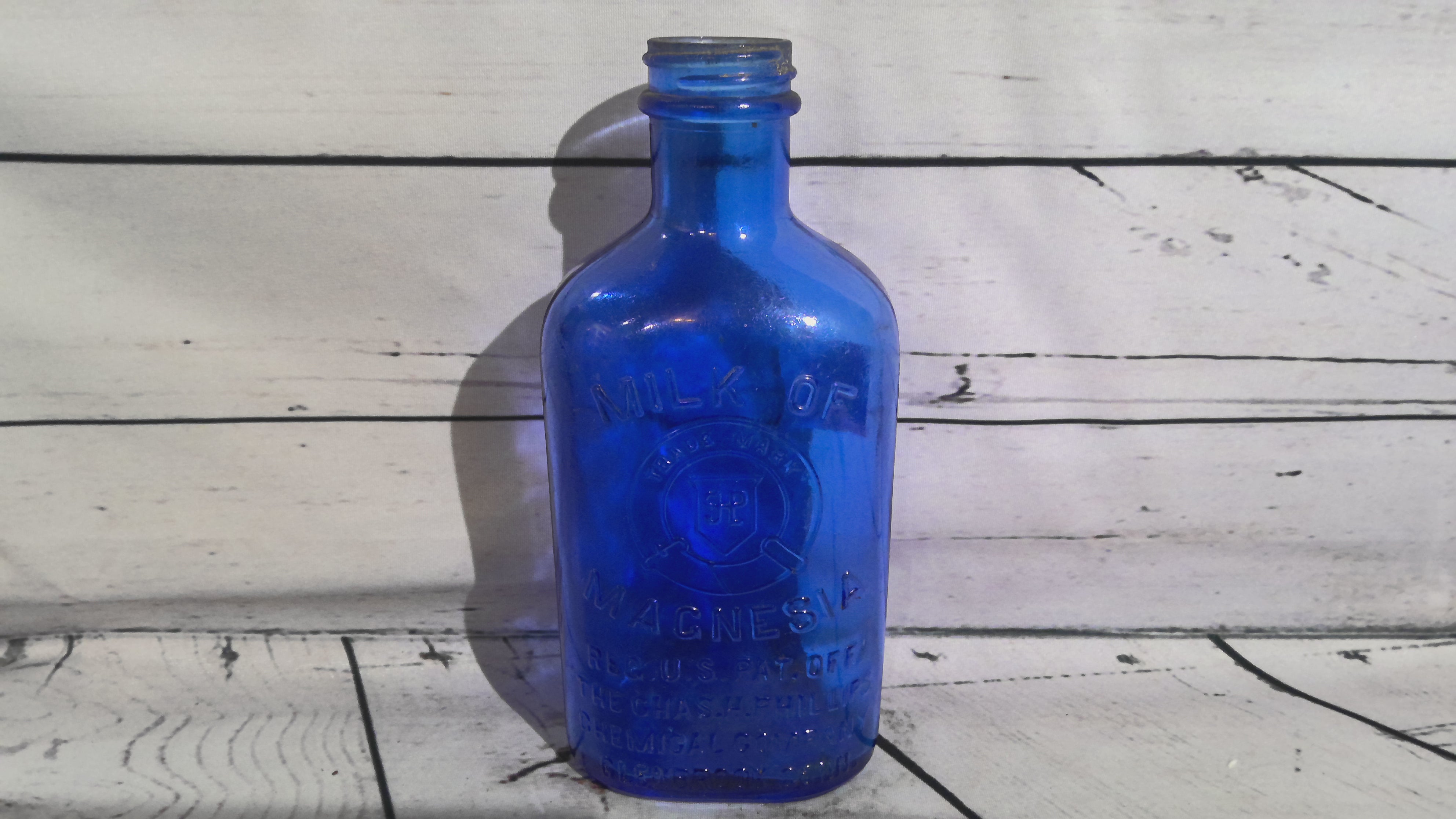 Vintage blue milk of magnesia bottle
