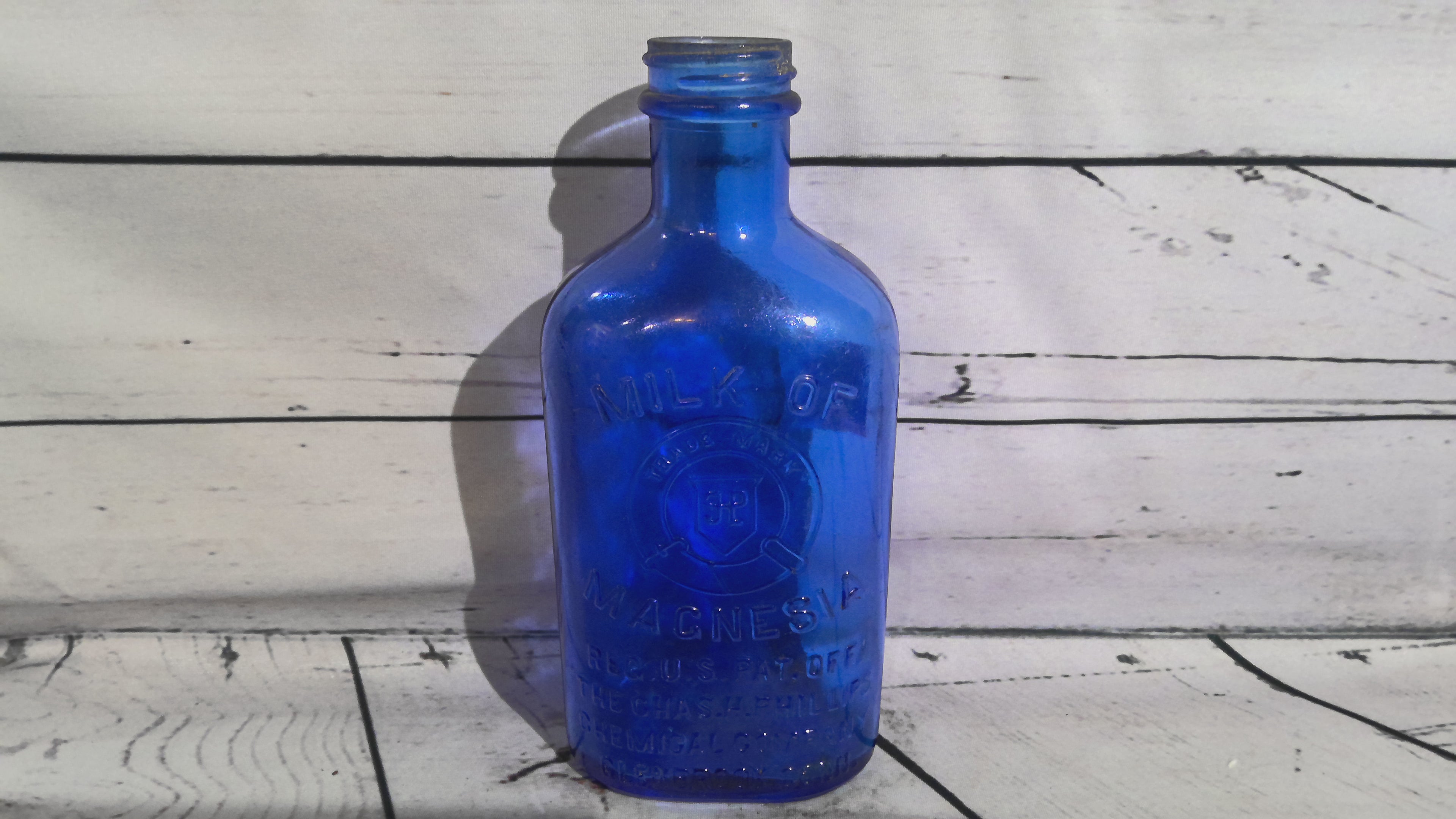 Vintage blue milk of magnesia bottle