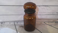 Brown glass jar with round lid