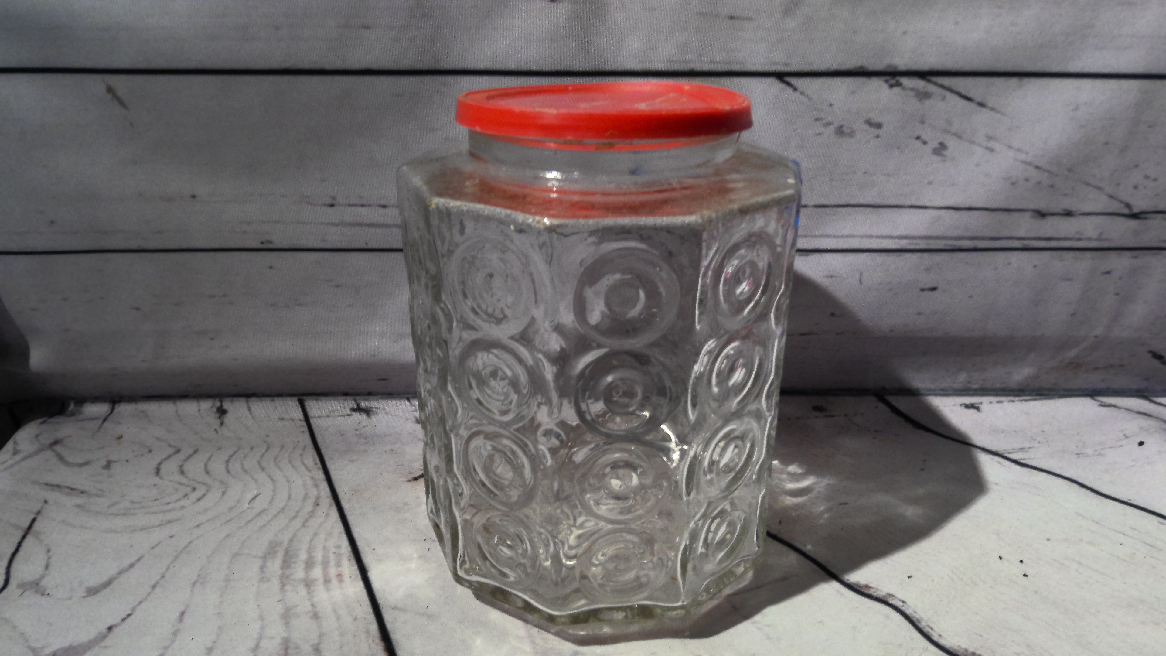 Glass jar with red lid